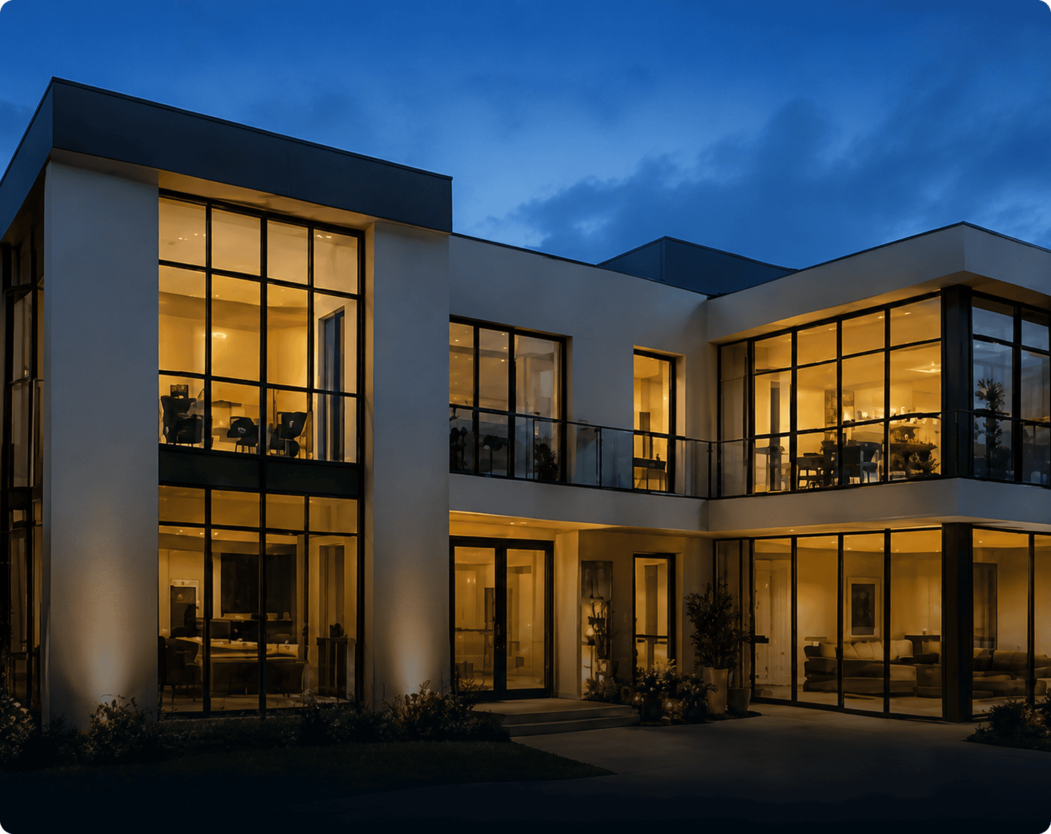 Modern two-story house with illuminated floor-to-ceiling windows